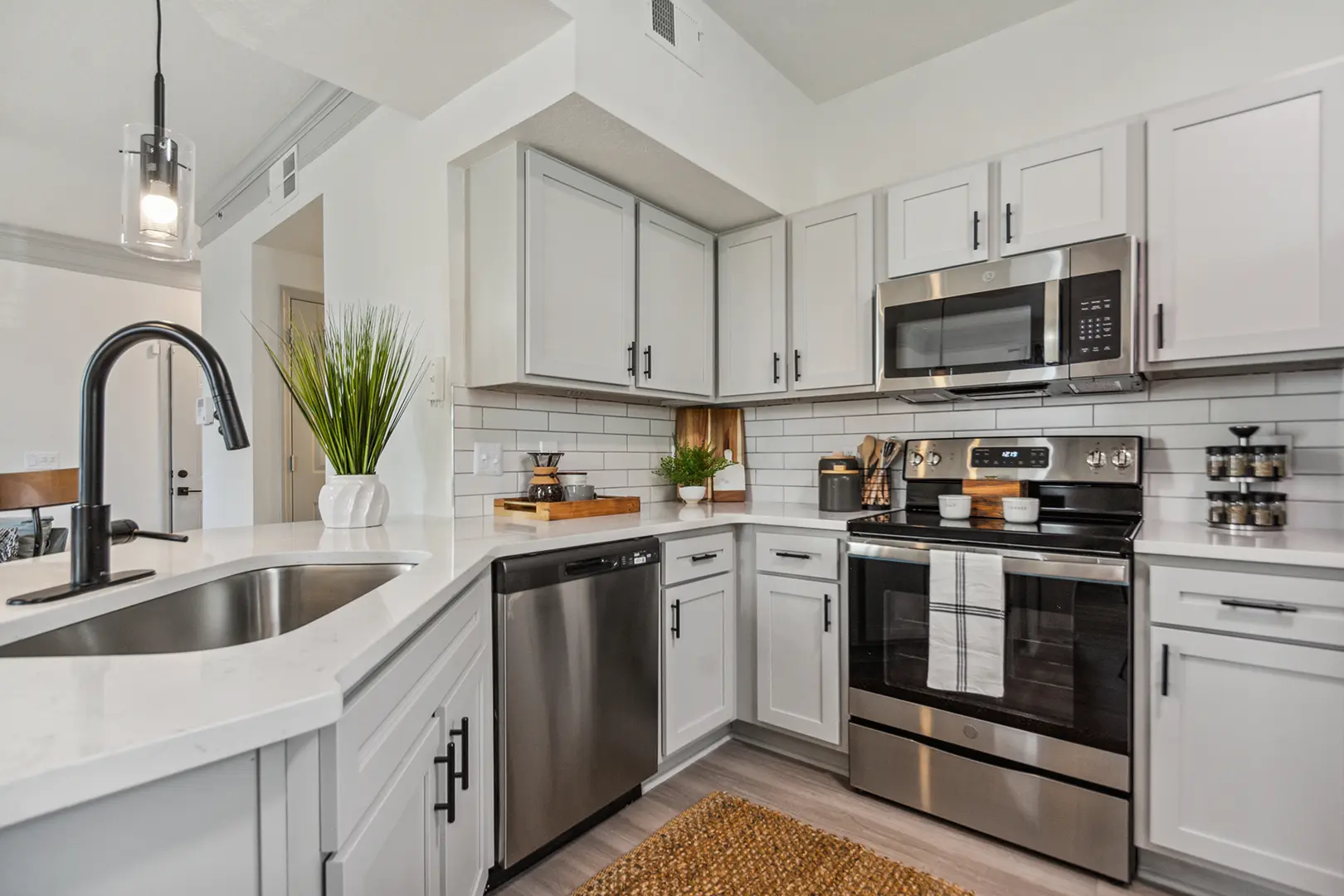 Kitchen with grey cabinets and stainless steel appliances
