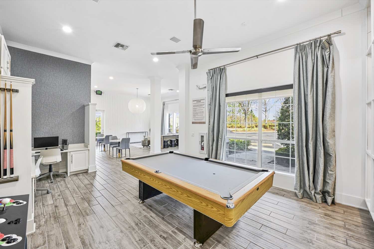 resident activity lounge with billiards table and wood-style flooring