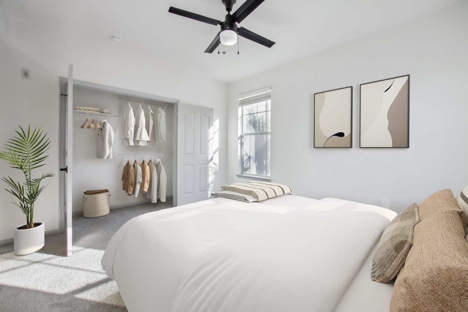 bedroom with wood-style flooring, reach-in closet, and ceiling fan