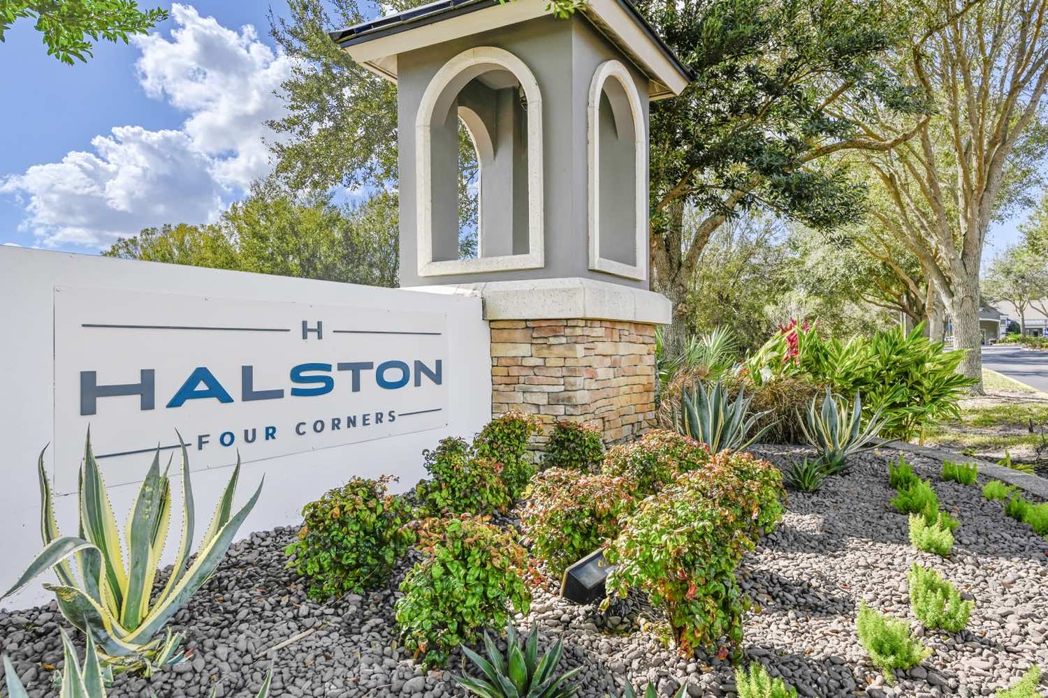 Halston Four Corners signage surrounded by landscaping