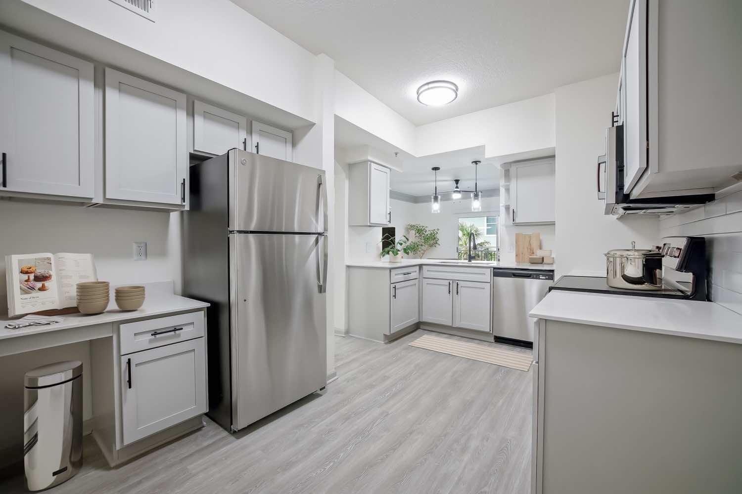 kitchen with wood-style flooring and stainless appliance package with built-in microwave